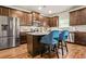 Kitchen with stainless steel appliances, stylish island with seating, and ample cabinet space at 113 Expedition Dr, Ellenwood, GA 30294