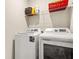 Functional laundry room with modern washer, dryer, and plenty of storage shelves at 113 Expedition Dr, Ellenwood, GA 30294