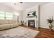 Bright living room with fireplace, large television, and a comfortable seating area at 113 Expedition Dr, Ellenwood, GA 30294