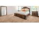 Main bedroom featuring tan carpet, neutral walls, and a large carved-wood bed frame at 113 Expedition Dr, Ellenwood, GA 30294
