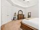 Main bedroom featuring tan carpet, neutral walls, and a dark wood dresser at 113 Expedition Dr, Ellenwood, GA 30294