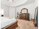 Main bedroom featuring tan carpet, neutral walls, and a large carved-wood dresser at 113 Expedition Dr, Ellenwood, GA 30294