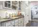 Cozy bar area features a sink, stone countertop, and custom white cabinets, perfect for entertaining guests at 3938 Hillsman Ln, Marietta, GA 30062