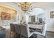 Elegant dining room boasts a beaded chandelier, brick accent wall, and views of the foyer at 3938 Hillsman Ln, Marietta, GA 30062