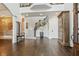 Spacious foyer with hardwood floors, staircase with iron railing, and brick accent wall exudes elegance at 3938 Hillsman Ln, Marietta, GA 30062