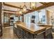 Stunning kitchen features wood beams, oversized island with wood counters and copper apron sink at 3938 Hillsman Ln, Marietta, GA 30062