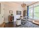 Bright office space with hardwood floors, decorative lighting fixture, large window, and stylish decor at 3938 Hillsman Ln, Marietta, GA 30062