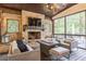 Inviting outdoor living space features stone fireplace and comfortable seating on a covered porch at 3938 Hillsman Ln, Marietta, GA 30062