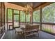 Enclosed porch featuring an outdoor dining space and views of the backyard at 3938 Hillsman Ln, Marietta, GA 30062