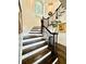 Detailed staircase with decorative iron railing and wood steps leads to the upper level and natural lighting at 3938 Hillsman Ln, Marietta, GA 30062