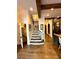 Elegant staircase with stone steps, dark wood handrail and wood beams above at 3938 Hillsman Ln, Marietta, GA 30062