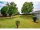 Expansive, lush backyard with mature trees and a wooden fence, perfect for outdoor activities at 4005 Brushymill Ct, Loganville, GA 30052