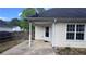 Backyard features a small covered patio and view of the home's back door at 4005 Brushymill Ct, Loganville, GA 30052