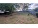 Sloped backyard with a wood fence and mature trees at 4005 Brushymill Ct, Loganville, GA 30052