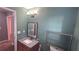 Bathroom features gray-green walls, granite countertop, and contemporary light fixture at 4005 Brushymill Ct, Loganville, GA 30052
