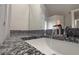 Granite countertop with a white sink and modern faucet in a well-lit bathroom at 4005 Brushymill Ct, Loganville, GA 30052