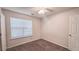 Bright bedroom with a ceiling fan and a window overlooking the landscaped yard at 4005 Brushymill Ct, Loganville, GA 30052