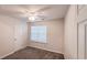 Well-lit bedroom with a large window, neutral carpet, and a ceiling fan at 4005 Brushymill Ct, Loganville, GA 30052