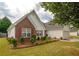Charming home featuring well-maintained lawn, red shutters, and partial brick facade at 4005 Brushymill Ct, Loganville, GA 30052