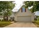 Charming home featuring a two-car garage, red shutters, and a well-maintained front lawn at 4005 Brushymill Ct, Loganville, GA 30052