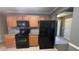 Traditional kitchen features oak cabinets, granite countertops, and black appliances at 4005 Brushymill Ct, Loganville, GA 30052