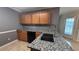 Modern kitchen featuring granite countertops, wood cabinetry, and stainless steel appliances at 4005 Brushymill Ct, Loganville, GA 30052