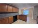 Well-equipped kitchen with wood cabinets, granite countertops, and tile flooring at 4005 Brushymill Ct, Loganville, GA 30052