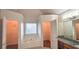 Main bathroom with and walk-in closets, soaking tub, and dual sinks at 4005 Brushymill Ct, Loganville, GA 30052