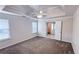 Spacious main bedroom with a coffered ceiling, fan, and neutral carpeting at 4005 Brushymill Ct, Loganville, GA 30052