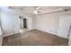 Large main bedroom with a coffered ceiling, fan, and neutral carpeting at 4005 Brushymill Ct, Loganville, GA 30052