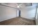 Carpeted main bedroom with a coffered ceiling and ceiling fan at 4005 Brushymill Ct, Loganville, GA 30052