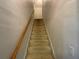 Carpeted stairway with wooden handrail, leading to the upper level at 4005 Brushymill Ct, Loganville, GA 30052