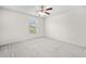 Cozy bedroom with carpet, a window, and a ceiling fan providing comfort at 4120 Cordova Ln, Cumming, GA 30028