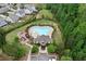An aerial view displays the community pool, clubhouse, and surrounding residential area at 4120 Cordova Ln, Cumming, GA 30028