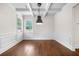 The dining room features wainscoting and a modern light fixture at 4120 Cordova Ln, Cumming, GA 30028