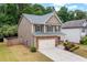 Well-maintained two-story home with neutral siding, a two-car garage, and landscaping at 4120 Cordova Ln, Cumming, GA 30028