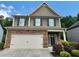 Beautiful two-story home with a stone-accented front, two-car garage, and nicely manicured landscaping at 4120 Cordova Ln, Cumming, GA 30028