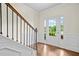 Inviting foyer featuring hardwood floors, a staircase with iron spindles, and a bright, welcoming atmosphere at 4120 Cordova Ln, Cumming, GA 30028