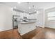 Beautiful kitchen featuring white cabinetry, stainless steel appliances, an island, and hardwood floors at 4120 Cordova Ln, Cumming, GA 30028