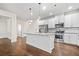 Beautiful kitchen with white cabinets, stainless steel appliances, and a granite island at 4120 Cordova Ln, Cumming, GA 30028