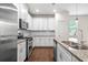 A modern kitchen with stainless steel appliances and granite countertops and subway tile backsplash at 4120 Cordova Ln, Cumming, GA 30028