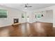 Living room featuring a cozy stone fireplace, many windows and wood floors at 4120 Cordova Ln, Cumming, GA 30028