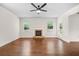 Bright living room with stone fireplace, wood floors and views to the outside at 4120 Cordova Ln, Cumming, GA 30028