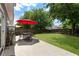 Private backyard featuring a patio, seating, green lawn, and mature trees at 5830 Sterling Ct, Cumming, GA 30040