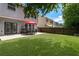 Spacious backyard with lush green lawn, patio area, and privacy fence at 5830 Sterling Ct, Cumming, GA 30040
