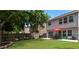 Large backyard with a well-maintained lawn, a patio area, and a charming swing at 5830 Sterling Ct, Cumming, GA 30040