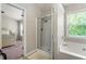 Bathroom features a shower and separate tub, next to a bedroom at 5830 Sterling Ct, Cumming, GA 30040
