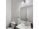 Half bath with modern faucet, framed mirror, towel ring, and a decorative towel at 5830 Sterling Ct, Cumming, GA 30040