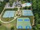 Aerial view of community featuring tennis and basketball courts, playground, clubhouse, and swimming pool with a slide at 5830 Sterling Ct, Cumming, GA 30040