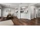 Open concept dining area with hardwood floors, a modern chandelier, and a view into the adjacent kitchen at 5830 Sterling Ct, Cumming, GA 30040